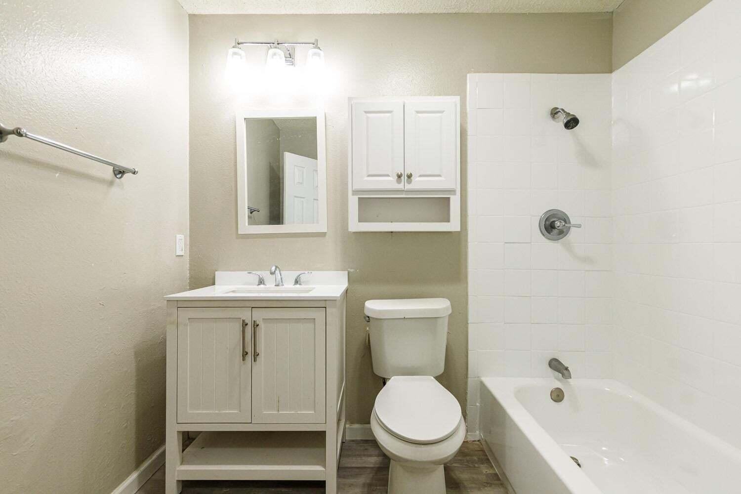 4634 Fordham Street Lubbock, TX 79416 - Photo 11 of 13 a bathroom with a sink a toilet and shower
