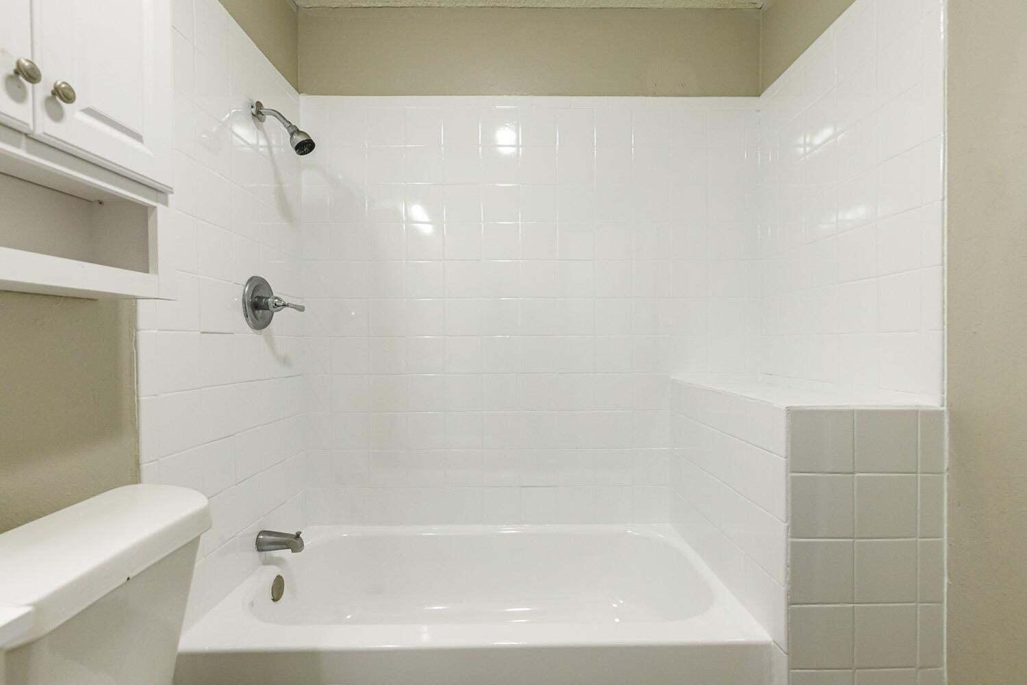 4634 Fordham Street Lubbock, TX 79416 - Photo 12 of 13 a bathroom with a bathtub
