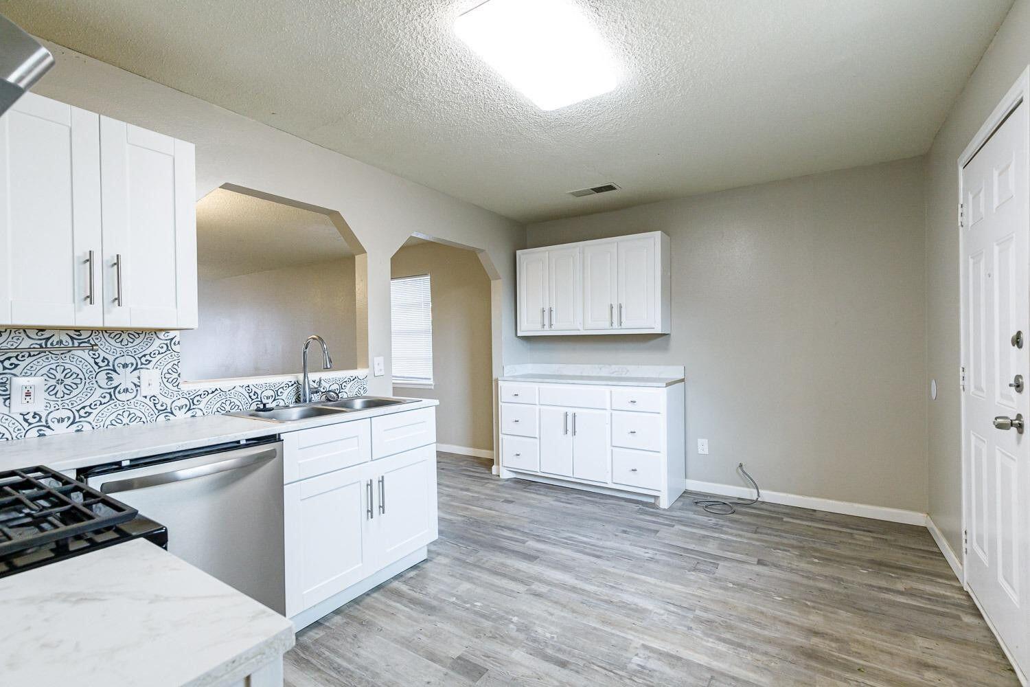 4634 Fordham Street Lubbock, TX 79416 - Photo 9 of 13 a kitchen with stainless steel appliances a stove and cabinets