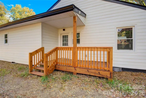 a view of a house with wooden fence