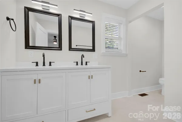 a bathroom with a double vanity sink mirror and