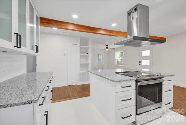 a kitchen with stainless steel appliances granite countertop a sink and a stove