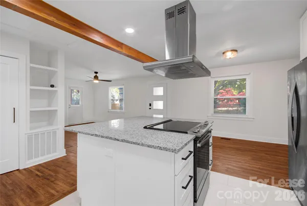 a kitchen with stainless steel appliances granite countertop a sink and a refrigerator