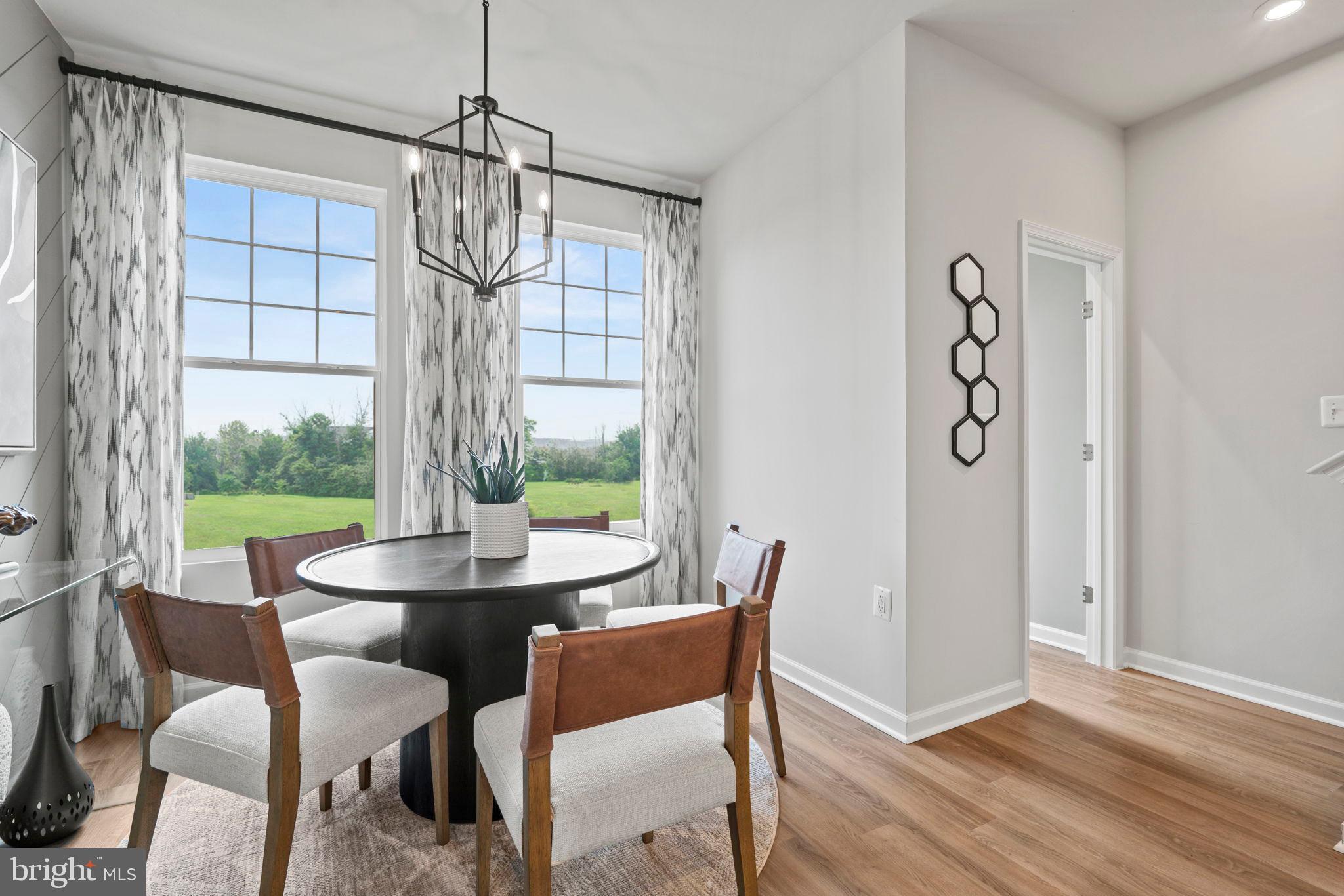 316 Presidents Pointe Avenue, Unit 613 Ranson, WV 25438 - Photo 50 of 87 a view of a dining room with furniture window and outside view