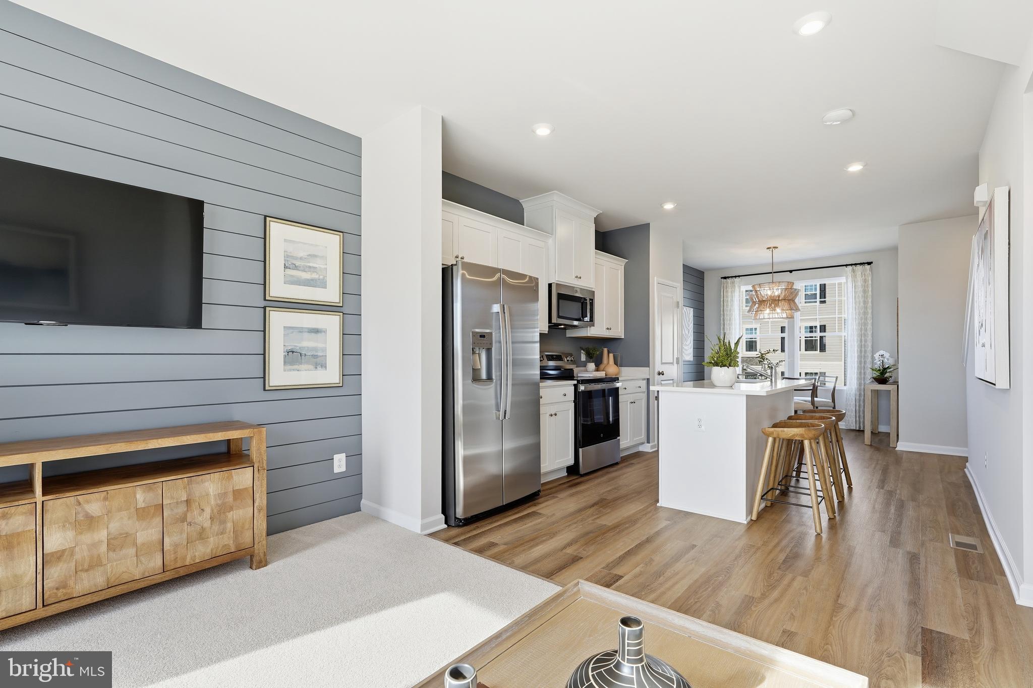 316 Presidents Pointe Avenue, Unit 613 Ranson, WV 25438 - Photo 52 of 87 a view of kitchen with refrigerator microwave and wooden floor