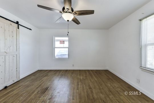 329 North Balsam Street Ridgecrest, CA 93555 - Photo 24 of 27 wooden floor in an empty room with a window
