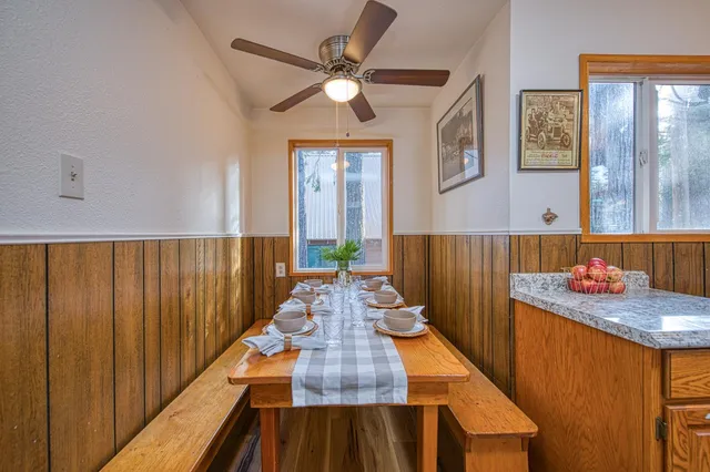 a room with a table chairs and a view of living room