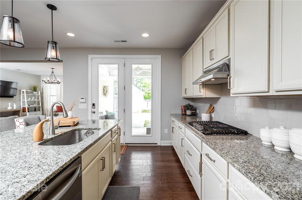 240 Helton Lane Fort Mill, SC 29708 - Photo 9 of 36 a kitchen with granite countertop stainless steel appliances a sink a stove top oven a counter space and cabinets
