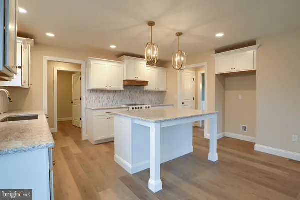 a kitchen with stainless steel appliances granite countertop wooden floors and sink