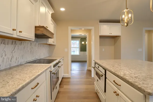 a kitchen with granite countertop a sink and a stove