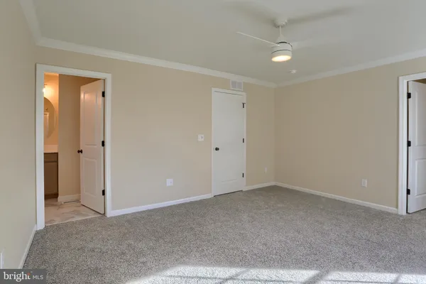 a bathroom with a granite countertop toilet a sink and a mirror