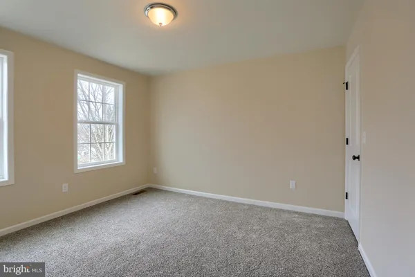 a view of empty room with wooden walls