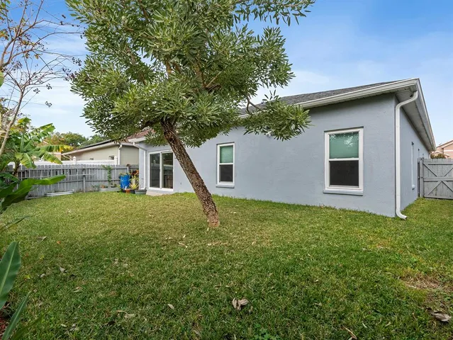 a house with green field in front of it