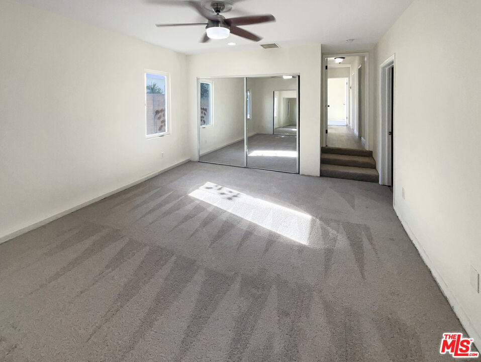 13242 Cornuta Avenue Downey, CA 90242 - Photo 5 of 19 an empty room with chandelier fan and windows