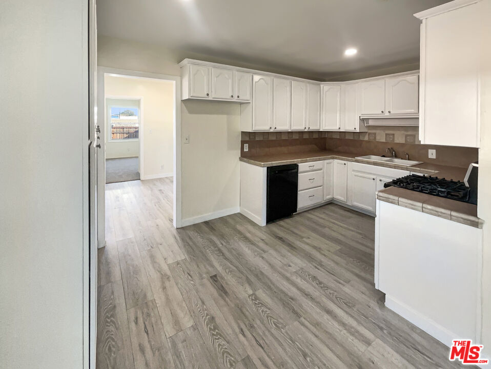13242 Cornuta Avenue Downey, CA 90242 - Photo 8 of 19 a kitchen with a refrigerator and a stove top oven
