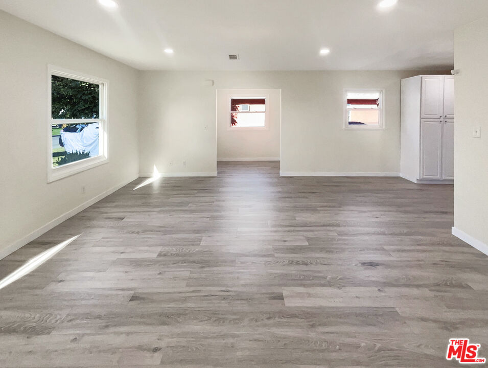 13242 Cornuta Avenue Downey, CA 90242 - Photo 9 of 19 a view of hallway with window and wooden floor