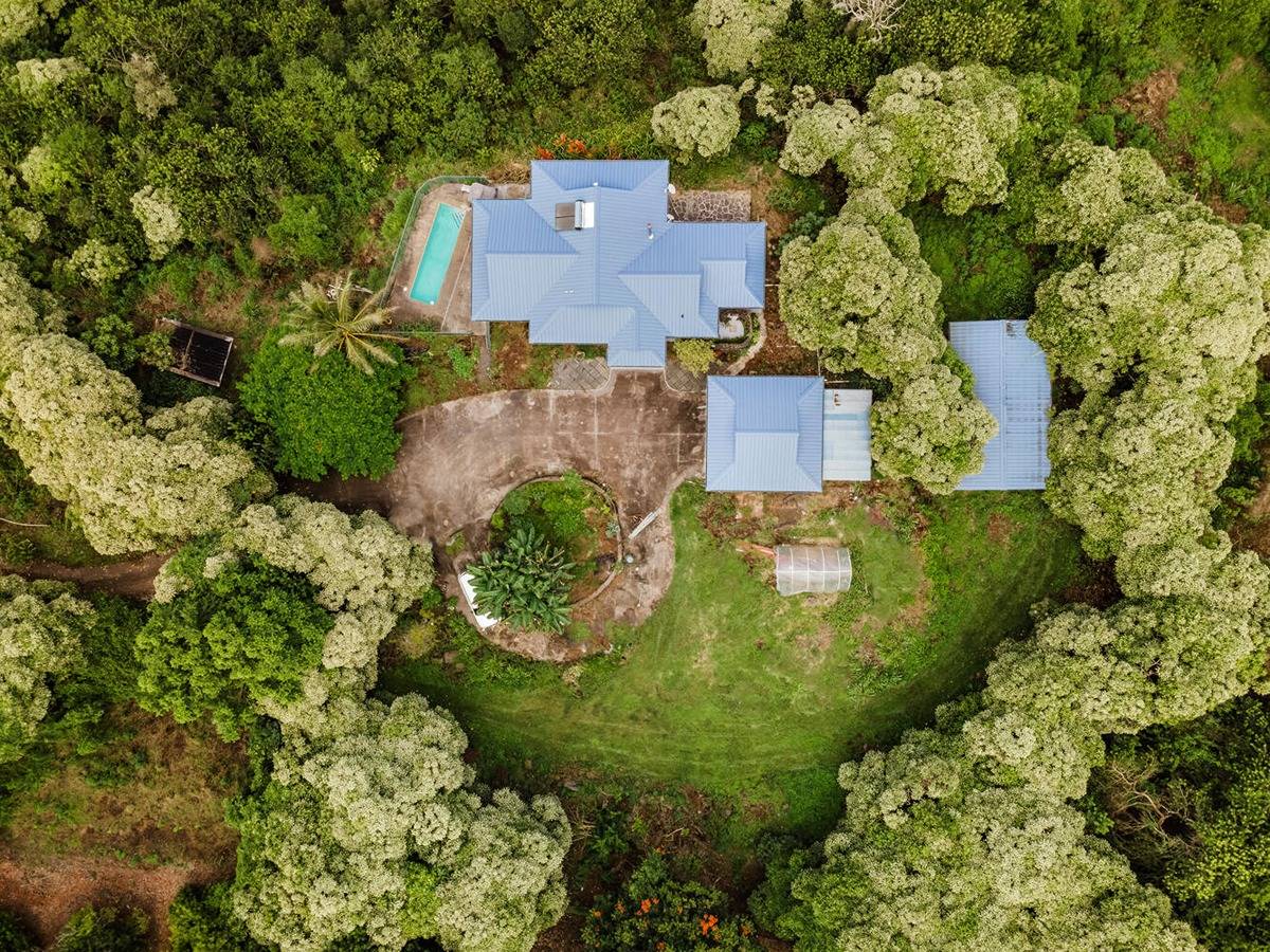 an aerial view of a house with a yard