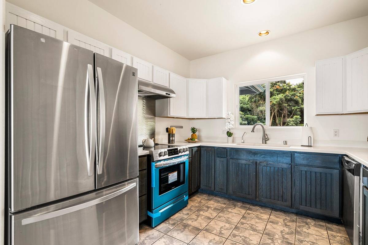 89-857 Hawaiʻi Belt Road Captain Cook, HI 96704 - Photo 12 of 30 a kitchen with stainless steel appliances granite countertop a refrigerator and a sink