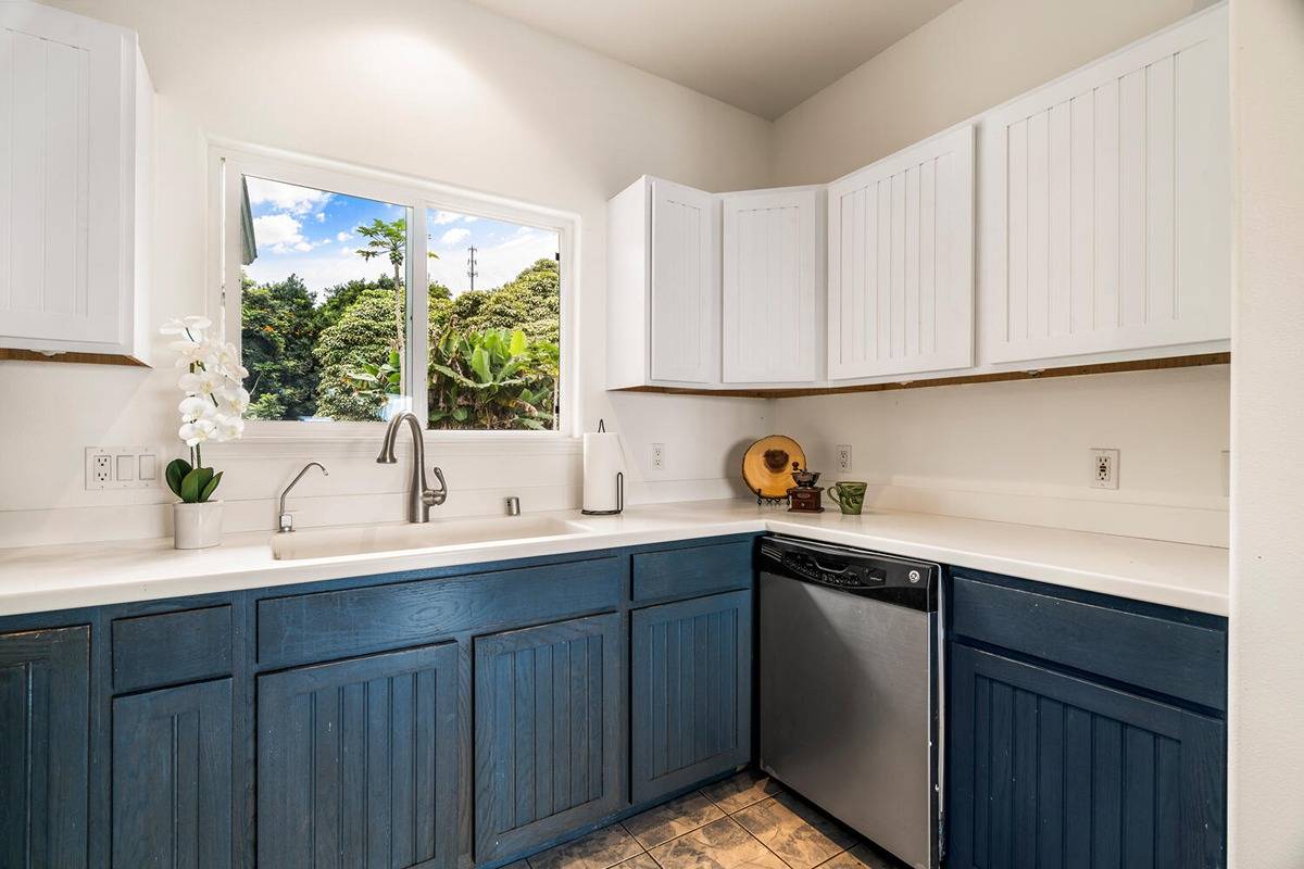 89-857 Hawaiʻi Belt Road Captain Cook, HI 96704 - Photo 23 of 30 a kitchen with a sink cabinets and window