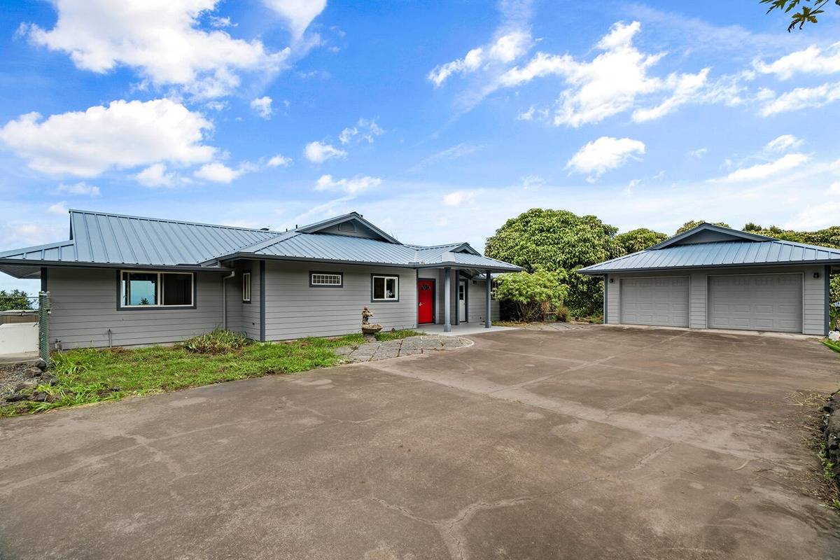 89-857 Hawaiʻi Belt Road Captain Cook, HI 96704 - Photo 25 of 30 a front view of a house with a yard and garage