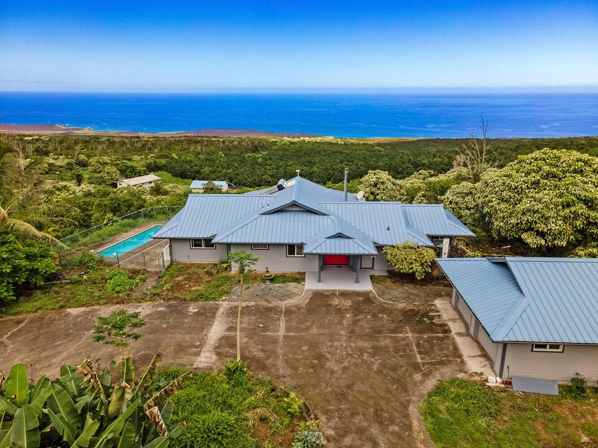 89-857 Hawaiʻi Belt Road Captain Cook, HI 96704 - Photo 3 of 30 an aerial view of residential houses with outdoor space