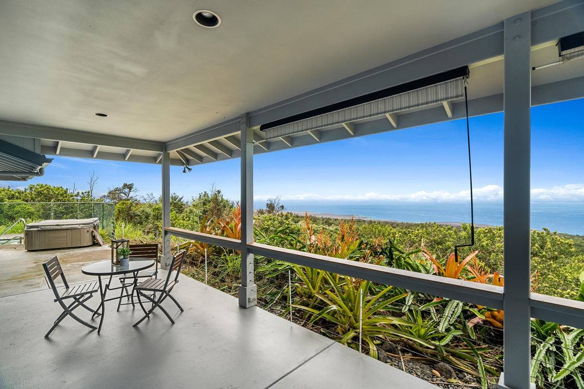 89-857 Hawaiʻi Belt Road Captain Cook, HI 96704 - Photo 9 of 30 a view of a chairs and table in patio