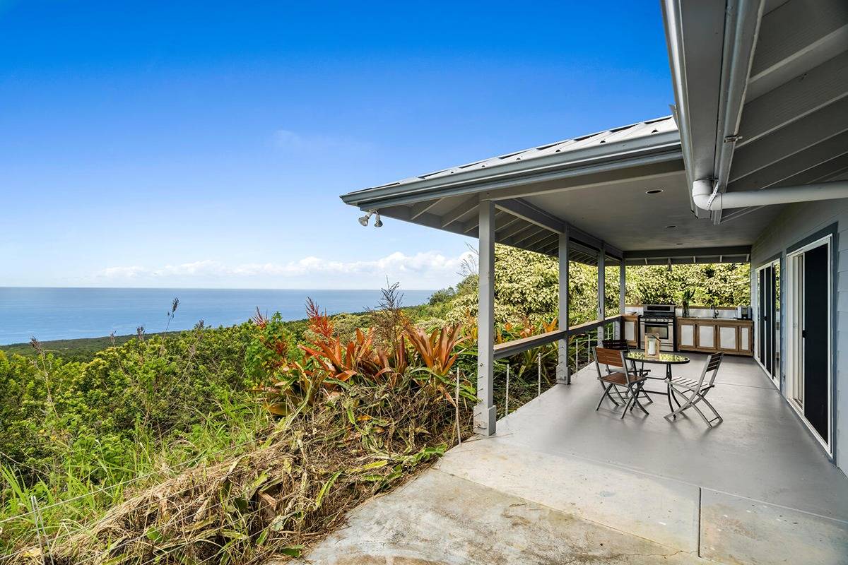 89-857 Hawaiʻi Belt Road Captain Cook, HI 96704 - Photo 10 of 30 a view of balcony with chairs and potted plants