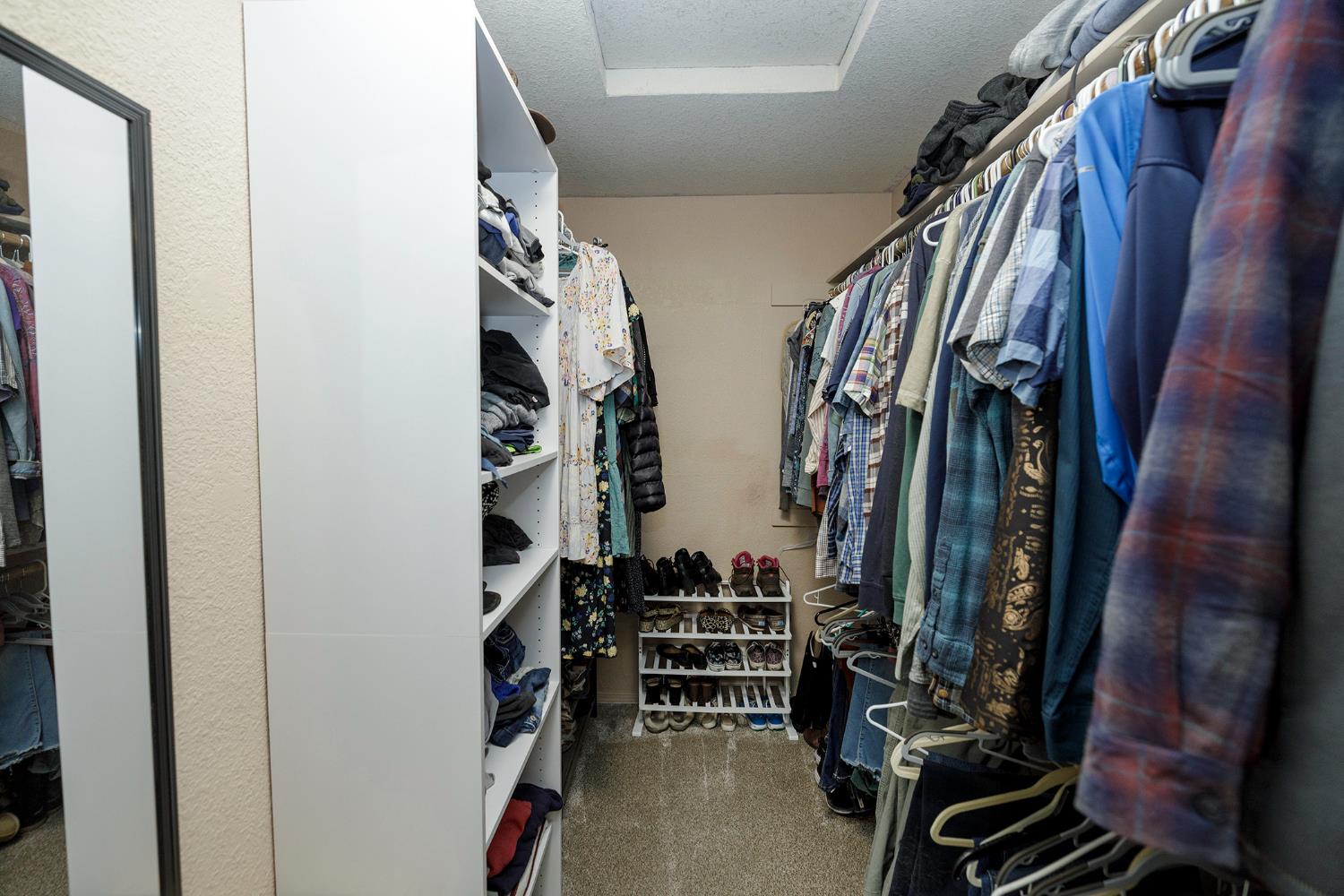 230 Meyenberg Avenue Ripon, CA 95366 - Photo 36 of 52 a view of walk in closet with clothes and shoes