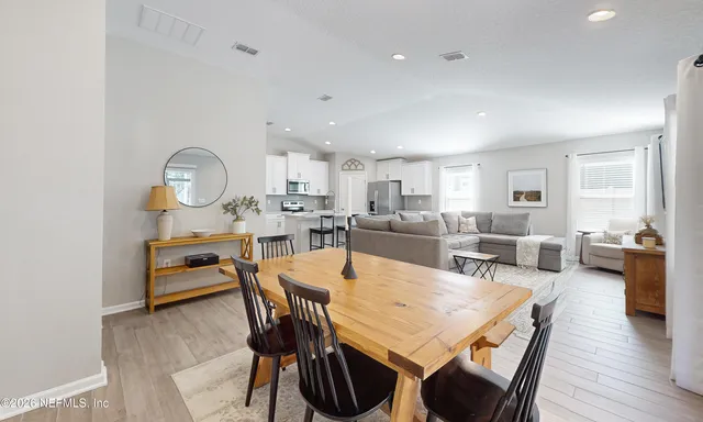a view of a hallway with bathroom and wooden floor