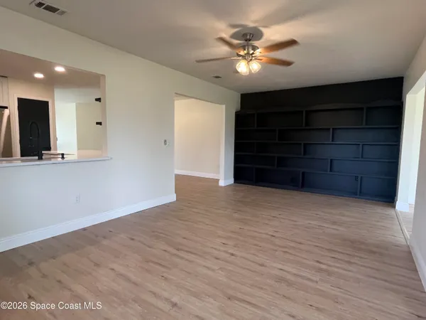 a view of an empty room with a cabinet