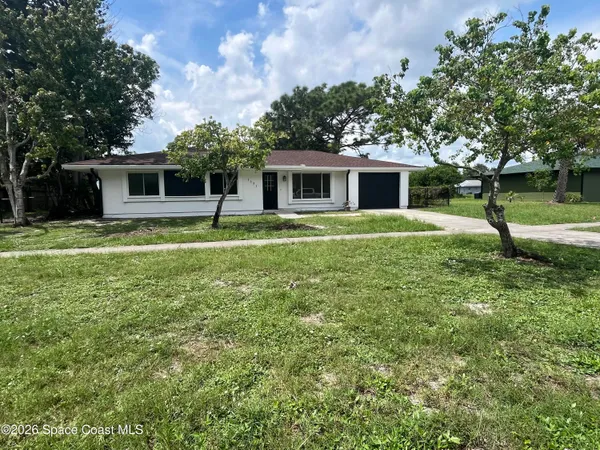 a house with trees in the background