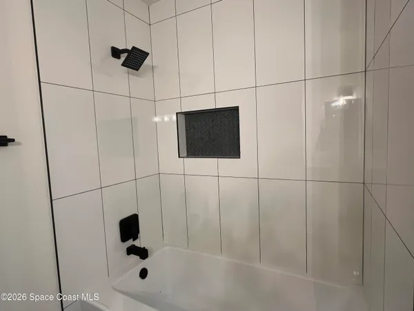 a bathroom with a shower and a mirror