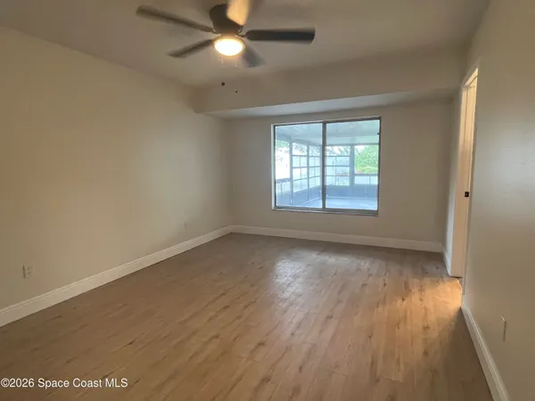 wooden floor in an empty room with a window