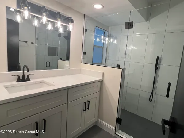 a bathroom with double vanity sink and a mirror