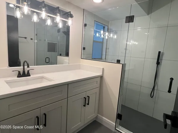a bathroom with a shower and a sink
