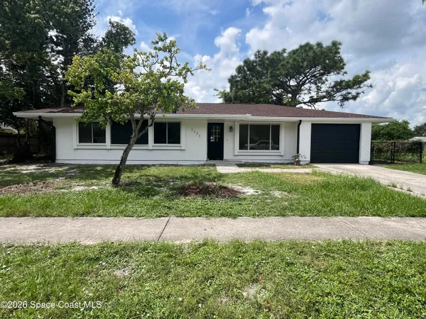 a house that has a tree in front of it