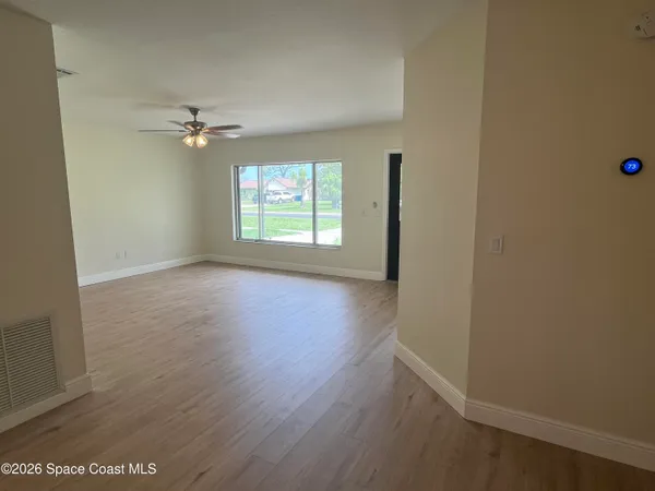 wooden floor in an empty room with a window