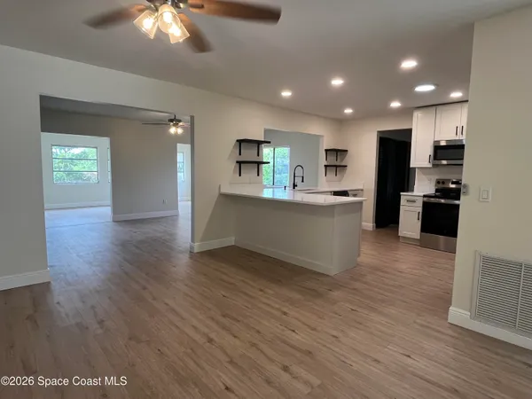 a view of kitchen with cabinets and wooden floor