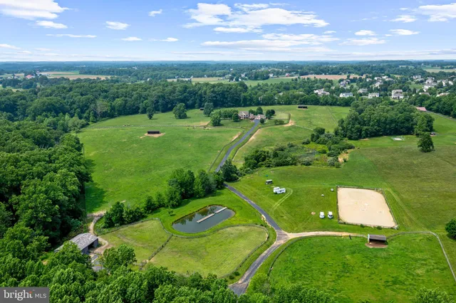 a view of a patio with a table and chairs under an umbrella