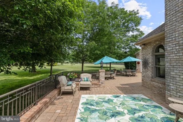 a living room with a bed furniture and a large window