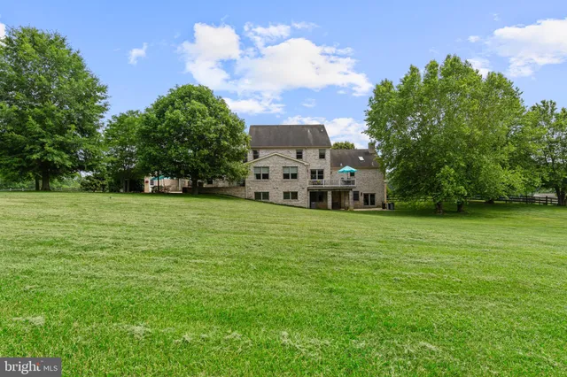 a en suite bathroom with a granite countertop sink and a mirror
