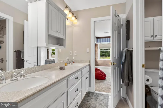 a large kitchen with granite countertop lots of counter top space and stainless steel appliances