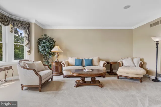 a kitchen with stainless steel appliances granite countertop a refrigerator a stove and white cabinets with wooden floors