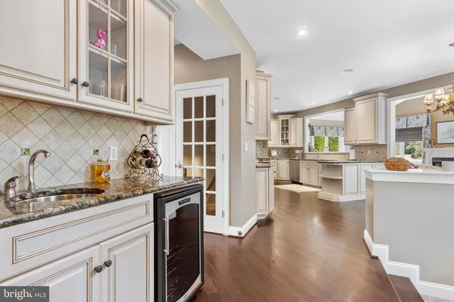 a spacious bedroom with a large bed and a chandelier