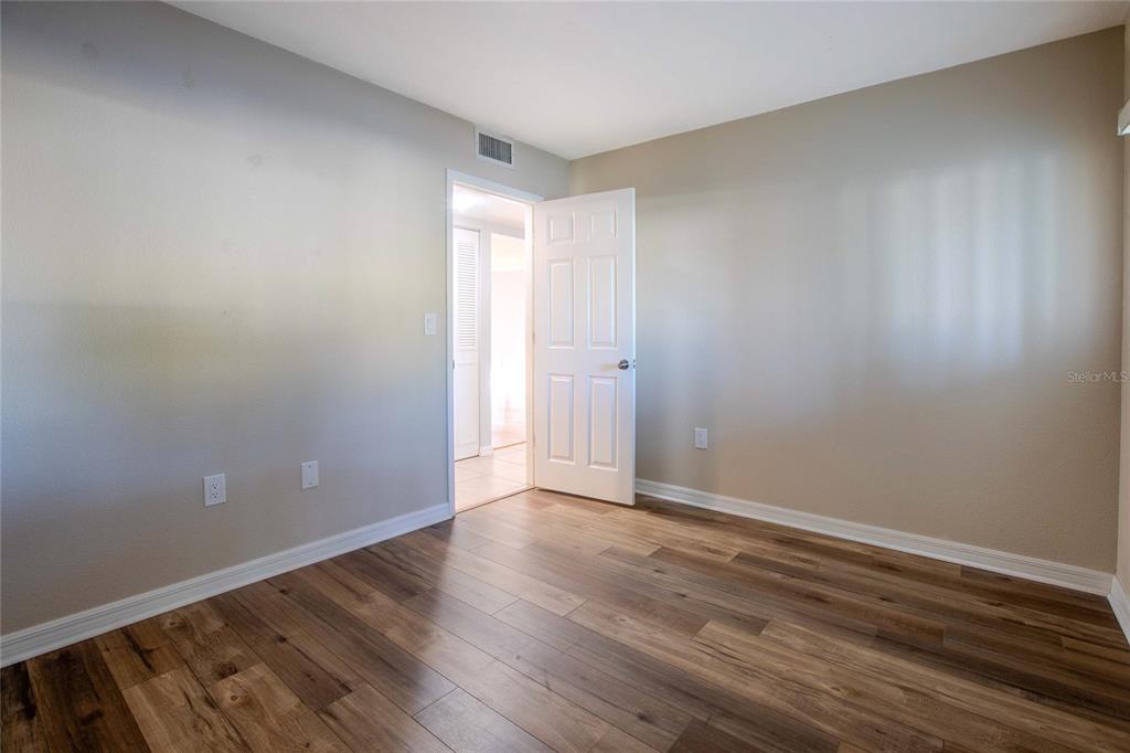 3300 South Beneva Road, Unit 214 Sarasota, FL 34232 - Photo 14 of 22 a view of an empty room with wooden floor