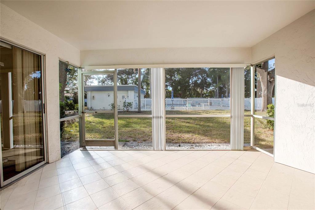 3300 South Beneva Road, Unit 214 Sarasota, FL 34232 - Photo 17 of 22 a view of a big room with floor to ceiling windows and an outdoor view