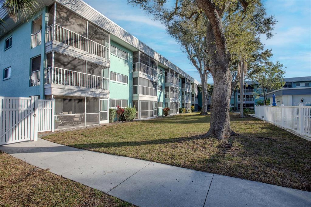 3300 South Beneva Road, Unit 214 Sarasota, FL 34232 - Photo 20 of 22 a view of a building with a yard