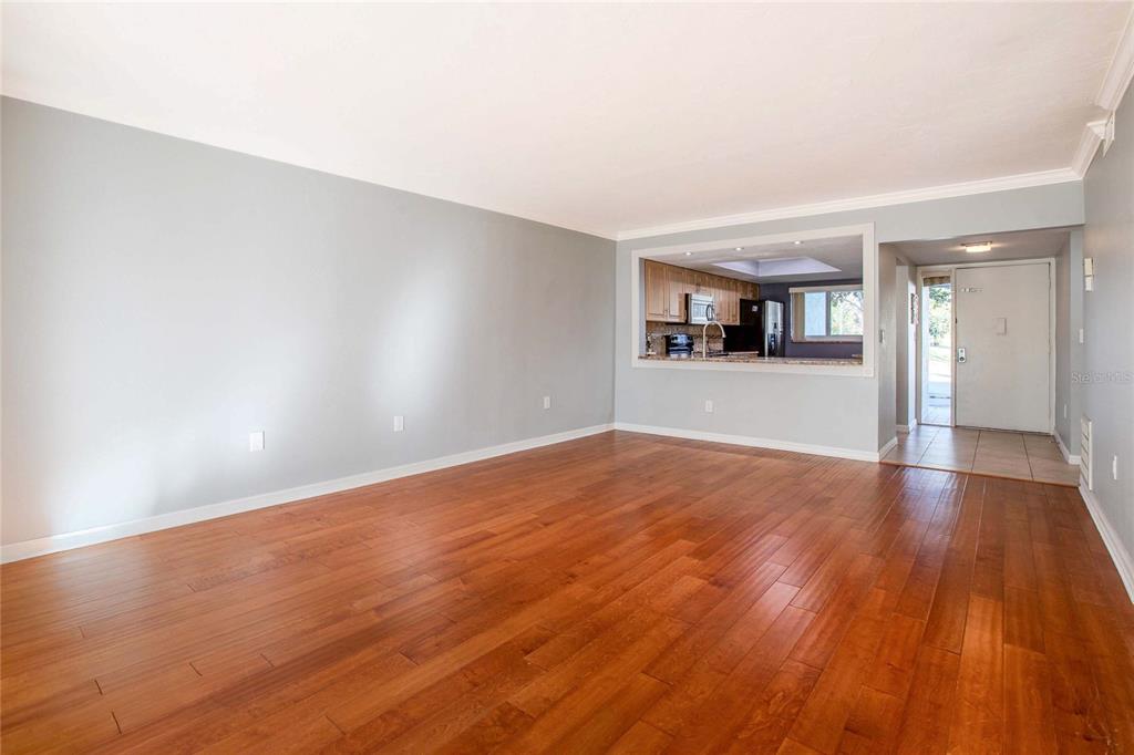 3300 South Beneva Road, Unit 214 Sarasota, FL 34232 - Photo 5 of 22 a view of empty room with wooden floor and fan