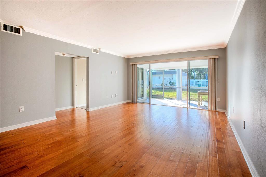3300 South Beneva Road, Unit 214 Sarasota, FL 34232 - Photo 7 of 22 wooden floor in an empty room with a window
