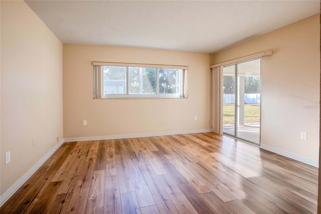 3300 South Beneva Road, Unit 214 Sarasota, FL 34232 - Photo 8 of 22 an empty room with wooden floor and windows